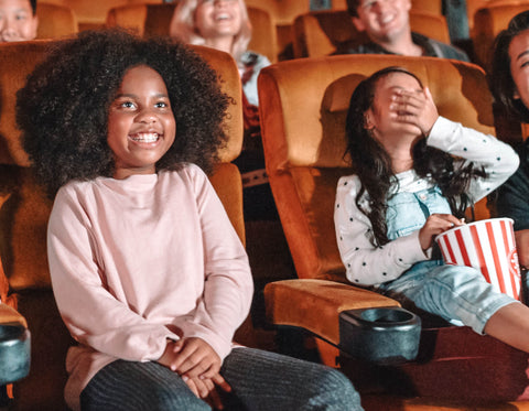 girls laughing in movie theater