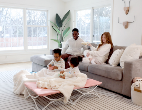 Family Sitting Around in Living Room Watching a Movie