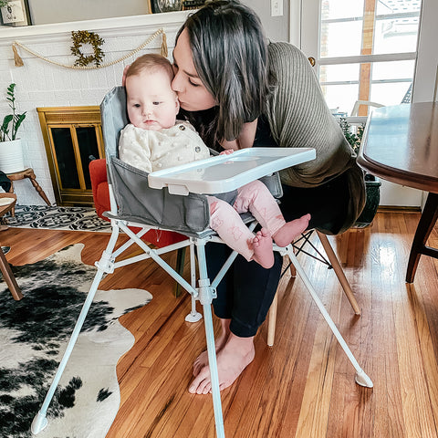 girl in a high chair with mom