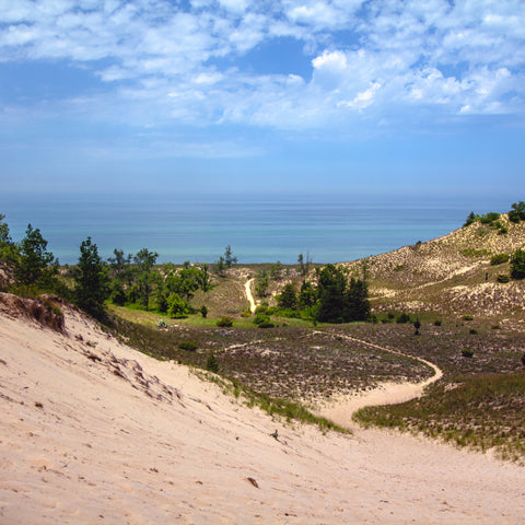 in-between two sand dunes on a path to the water at Indiana Dunes National Park 