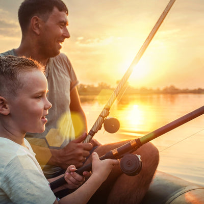 father son fishing while camping