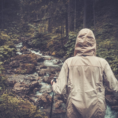 girl hiking in the rain but well prepared with rain gear 