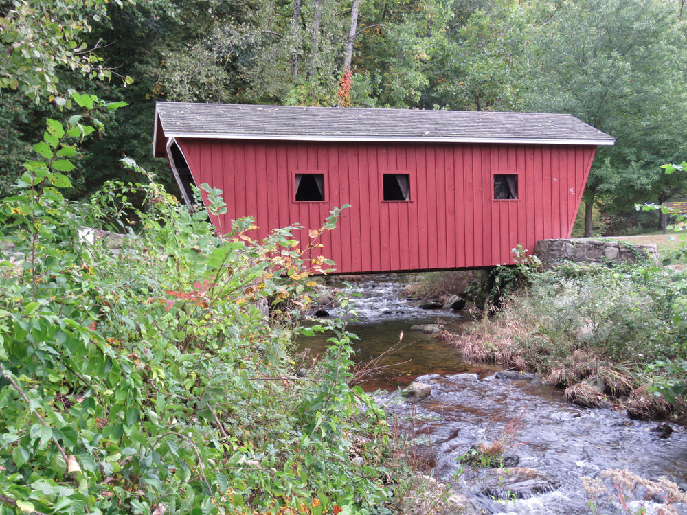 Red Covered Bridge Over Stream in Kent Falls State Park Connecticut