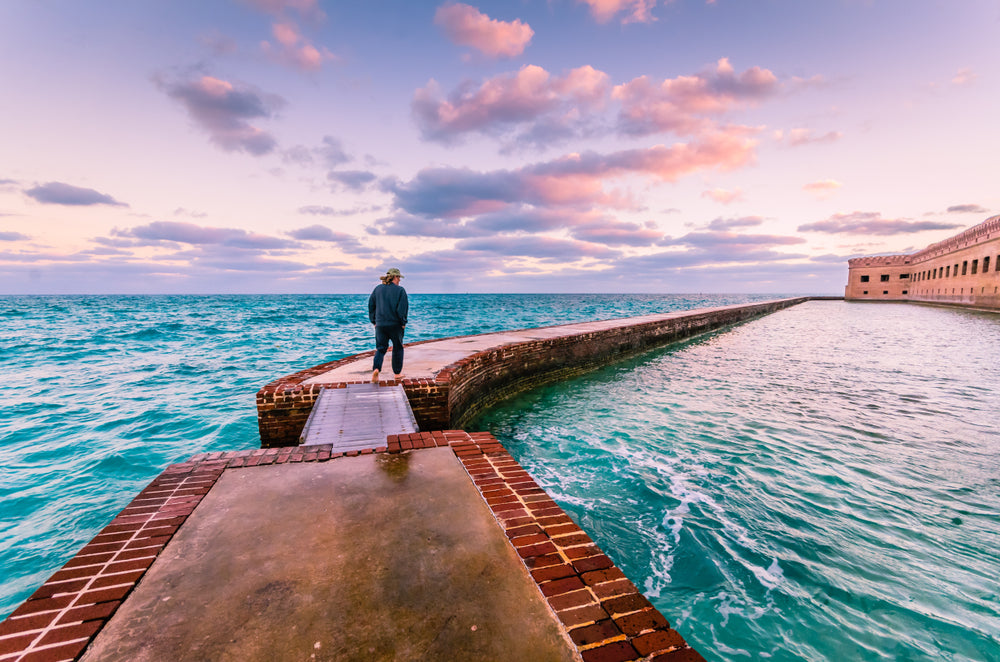 View of Man Walking on Moat Around Fort Jefferson in Dry Tortugas National Park Florida