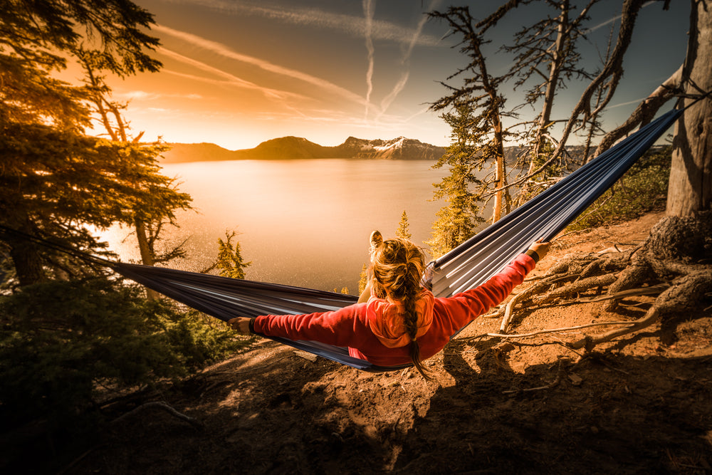 Woman Hiker Resting in Hammock Looking Out Over Crater Lake National Park in Oregon
