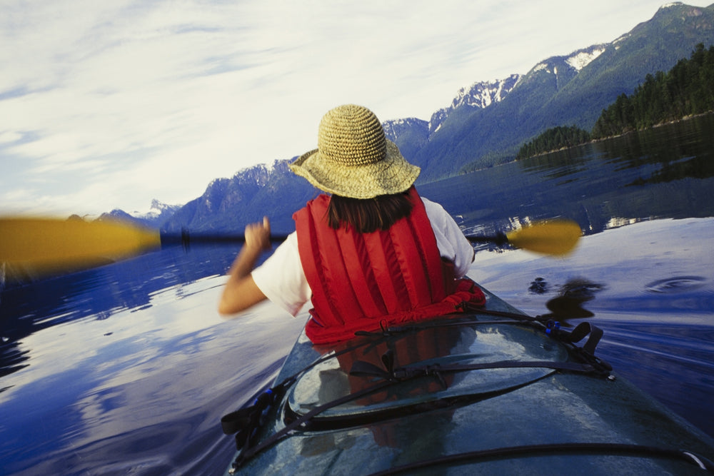 Woman Kayaking on Muir Inlet at Glacier Bay National Park Alaska