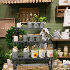 Garden planters and gift items displayed on potting table