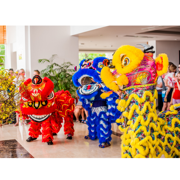 3 dragon dancers in costumes red blue and yellow