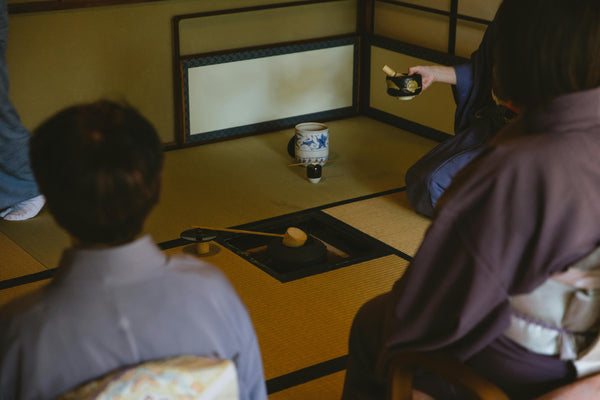 people around a tatami mat during a japanese tea ceremony