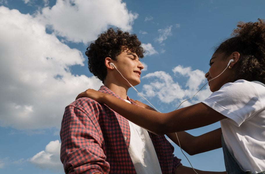 Photo by Ron Lach  from Pexels: https://www.pexels.com/photo/teenage-couple-sharing-headphones-against-blue-sky-9654031/