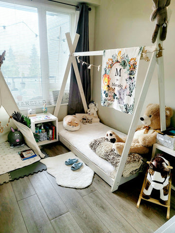 A kid's bedroom with a floor bed or montessori bed and baby sized furniture 