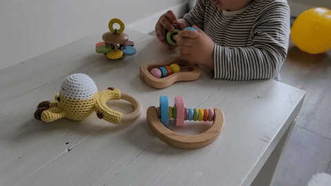 bebé jugando con su juego de juguetes de madera montessori para bebés