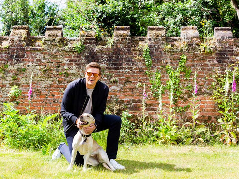 Jake Humphrey wearing sunglasses and Private White VC Jacket with dog