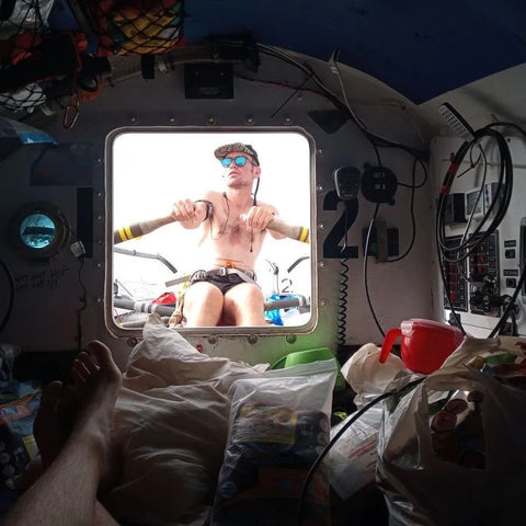 Atlantic rower wearing blue polarised sunglasses on boat