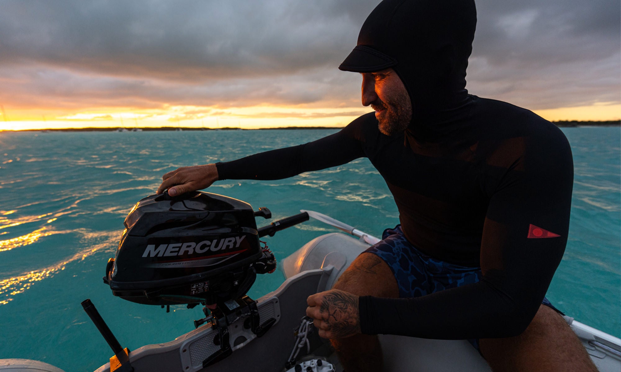 Sunset on the boat with a hooded rash guard