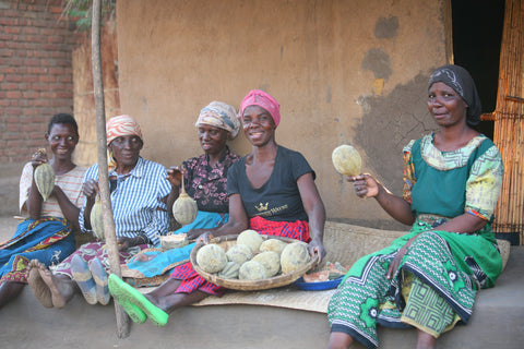 women in Malawi with Baobab fruit