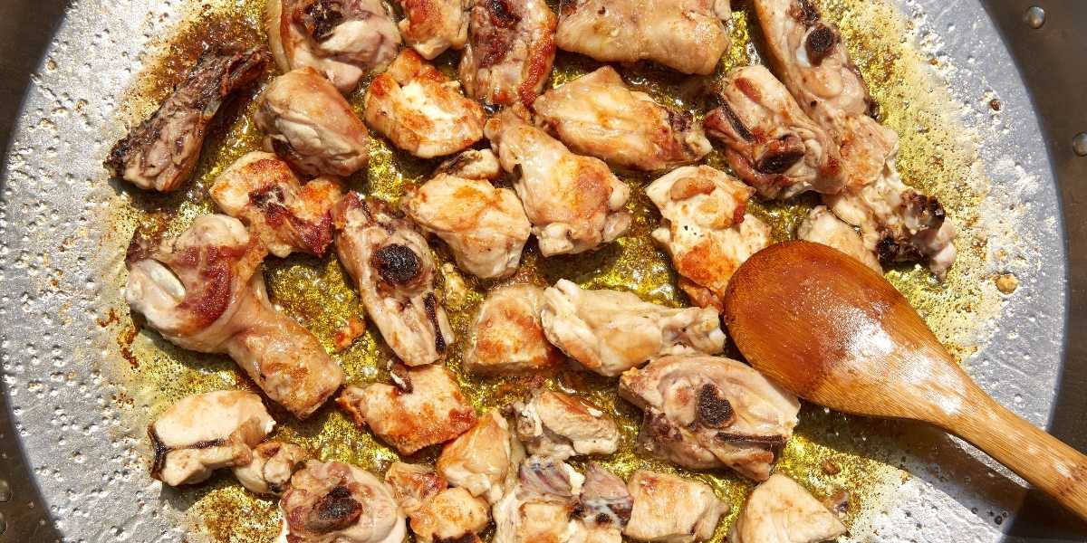 Rabbit meat for traditional paella cooking in paella pan