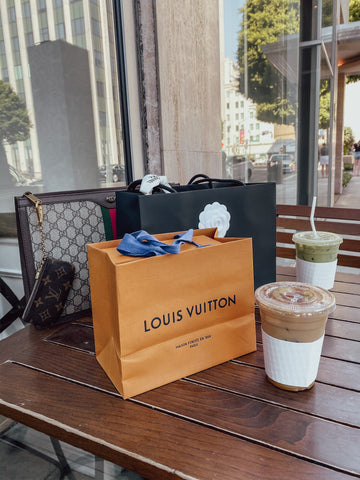 Designer Shopping bags on a Table with Two cups f iced coffee 