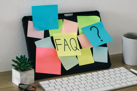 FAQ on post-its attached to laptop screen