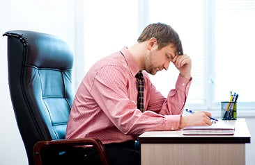 Man in pink shirt working at desk