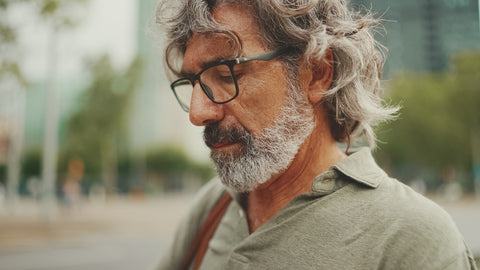 thoughtful looking middle aged man with grey hair