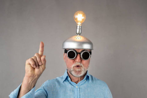 senior with lighted bulb on his head giving benefits of mental balance