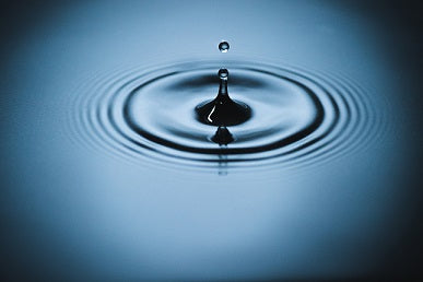 A drop of water on a deep blue lake