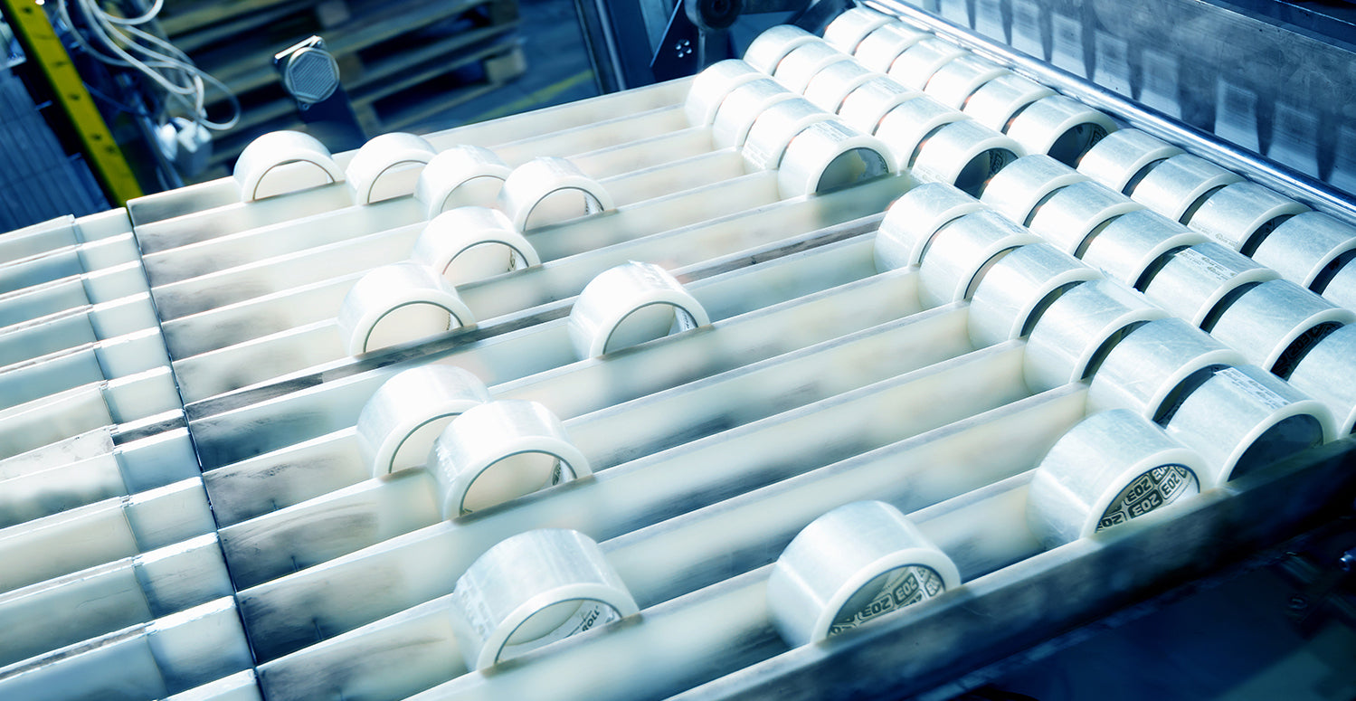 Photo of rolls of packing tape being produced on a machine