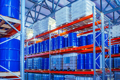 Chemical storage warehouse. Containers for chemical liquids. Warehouse system. Toxic barrels are kept in stock. Warehouse storage. Chemical Industry. Plastic barrels of chemicals are on pallets.