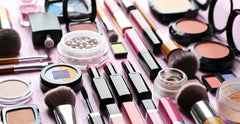 Cosmetics and makeup brushes displayed on a table