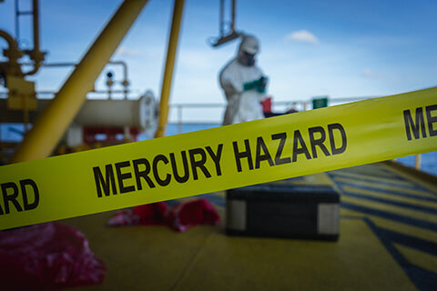 Mercury Hazard Caution tape around an industrial site.