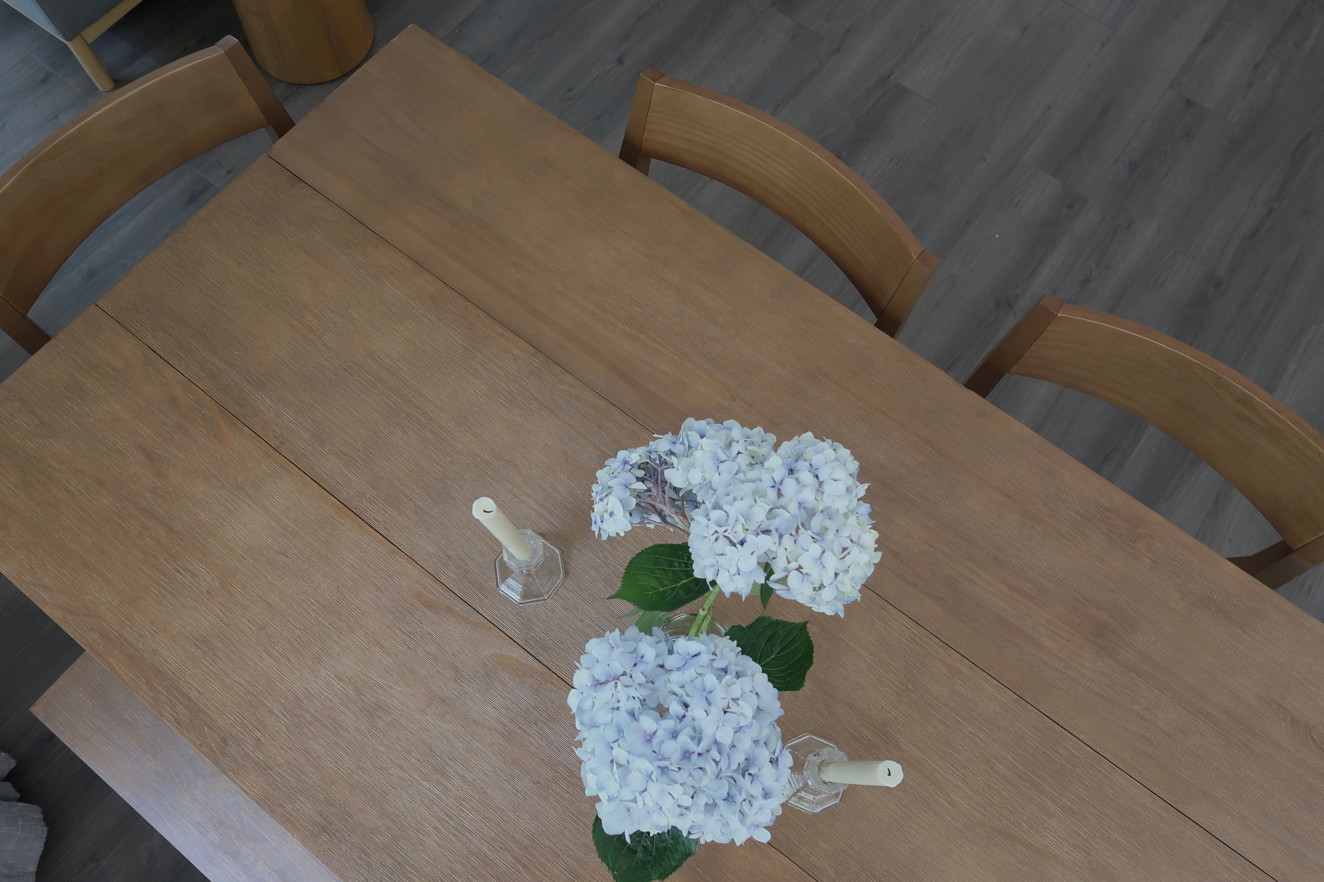 Solid Wood Dining Table Set in Pecan with Blue Flower Centerpiece and Candlesticks