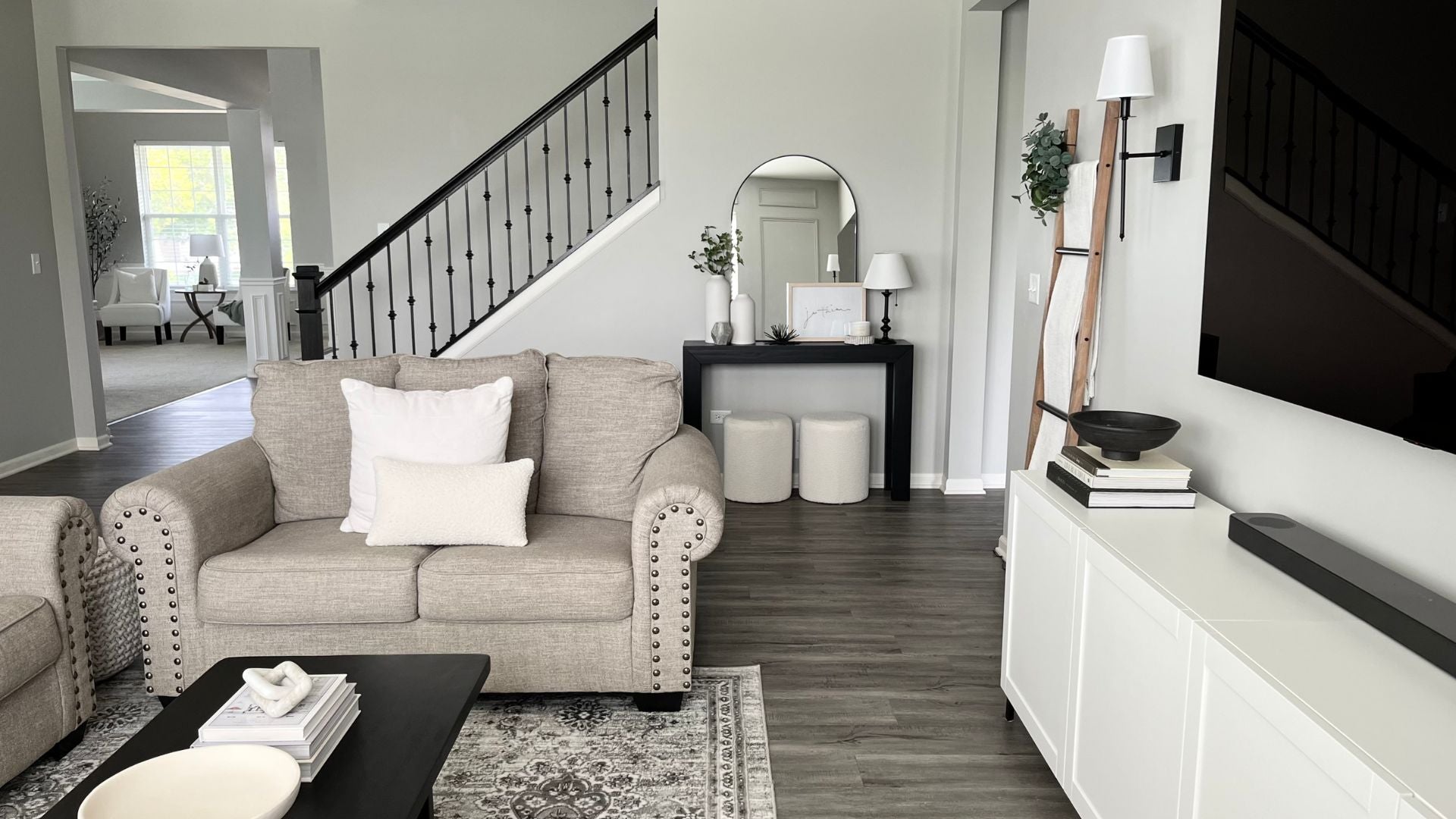 Black modern solid wood hallway table and black coffee table with light neutral decor