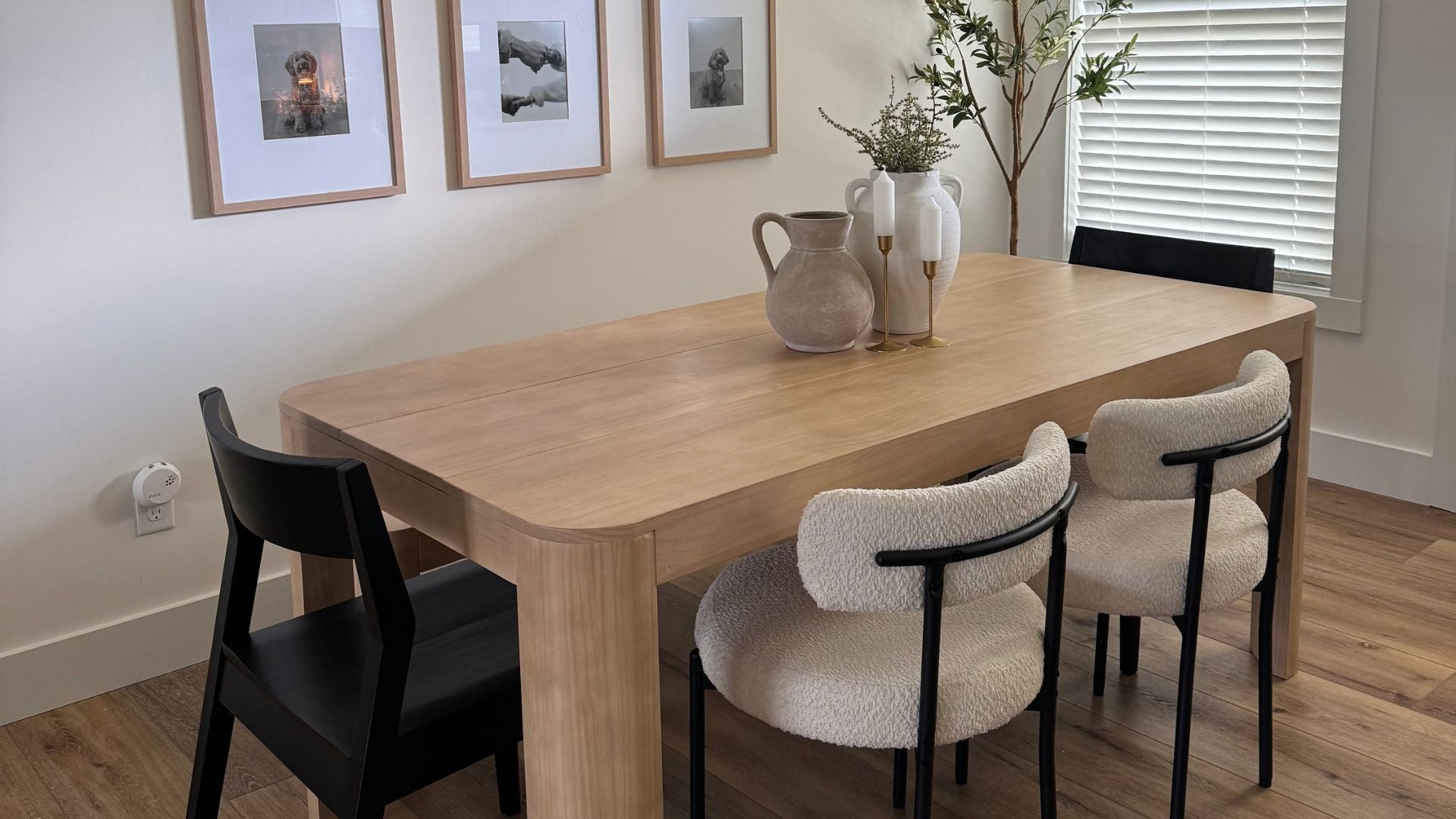 solid wood dining room table with two black solid wood dining chairs