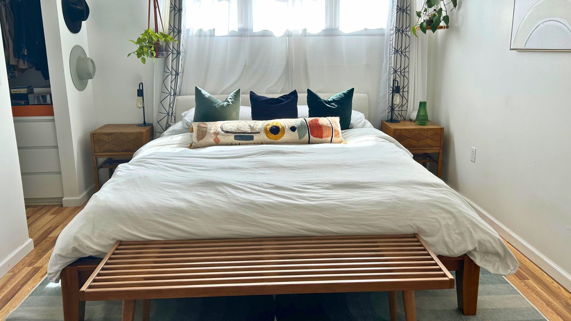 boho bedroom with solid wood bench at end of bed