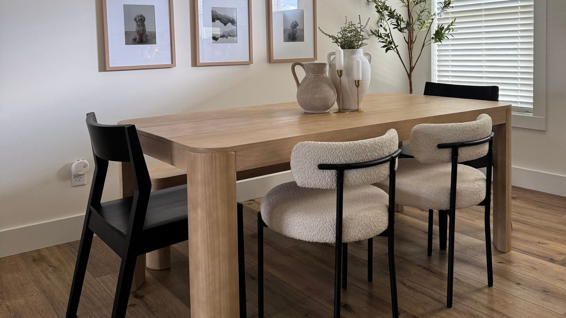 natural wood table with black dining chairs