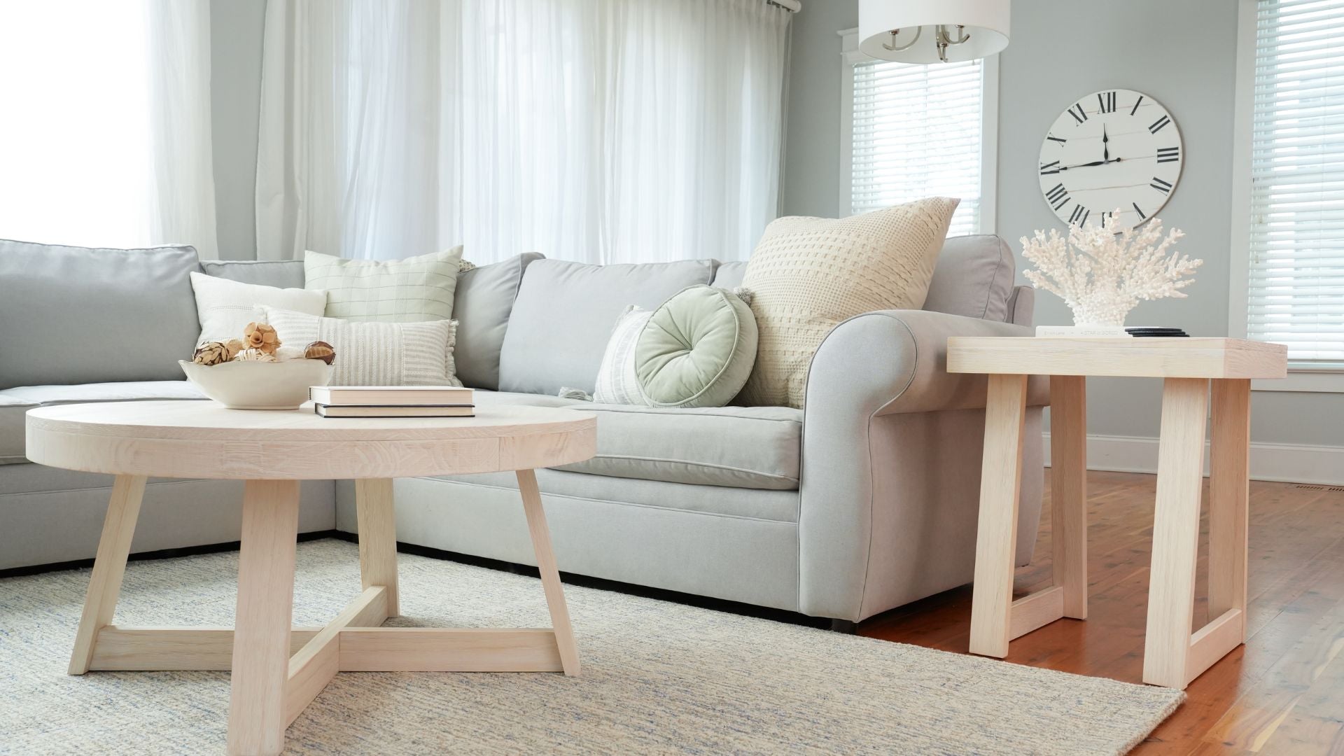 coastal living room with round coffee table and light wood side table