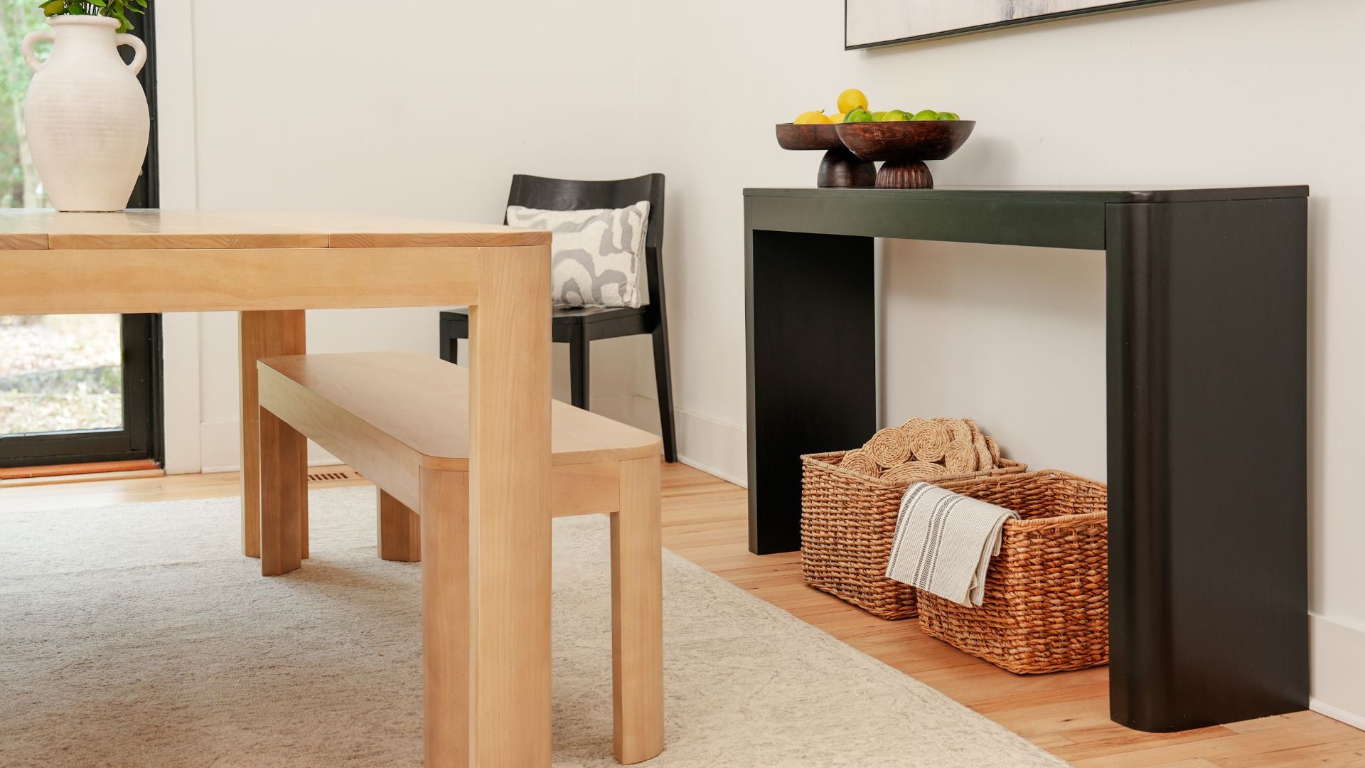 black console table and solid wood dining table with dining benches