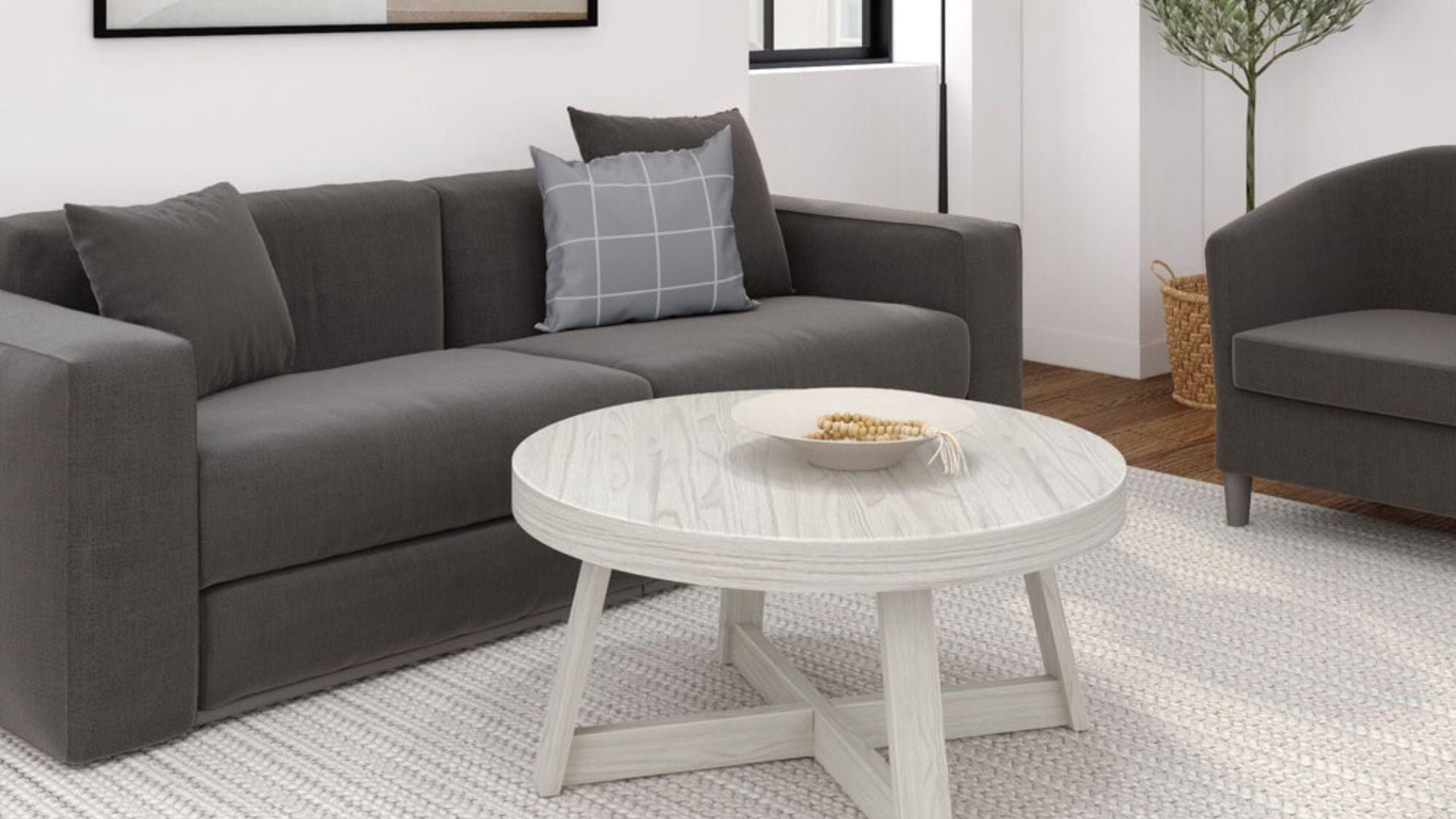 Solid wood circle coffee table in white sand with dark gray couch and white rug