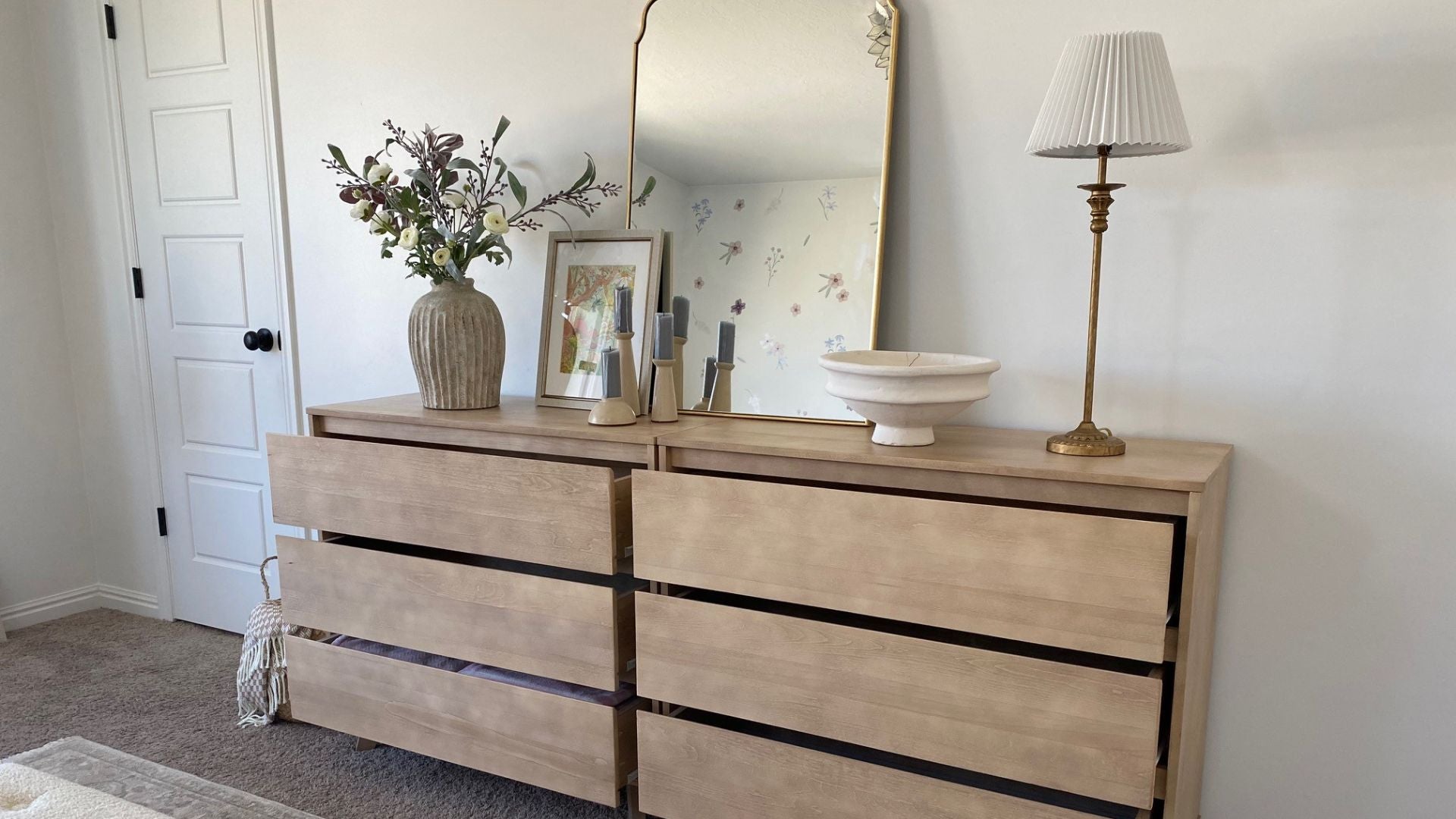 Two 3-drawer dressers with mirror, lamp, and flowers