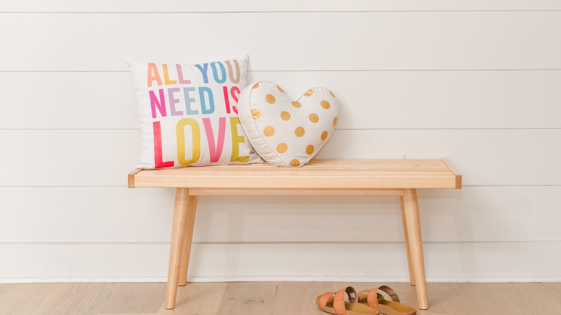 solid wood entryway bench with shoe storage and decorative pillows