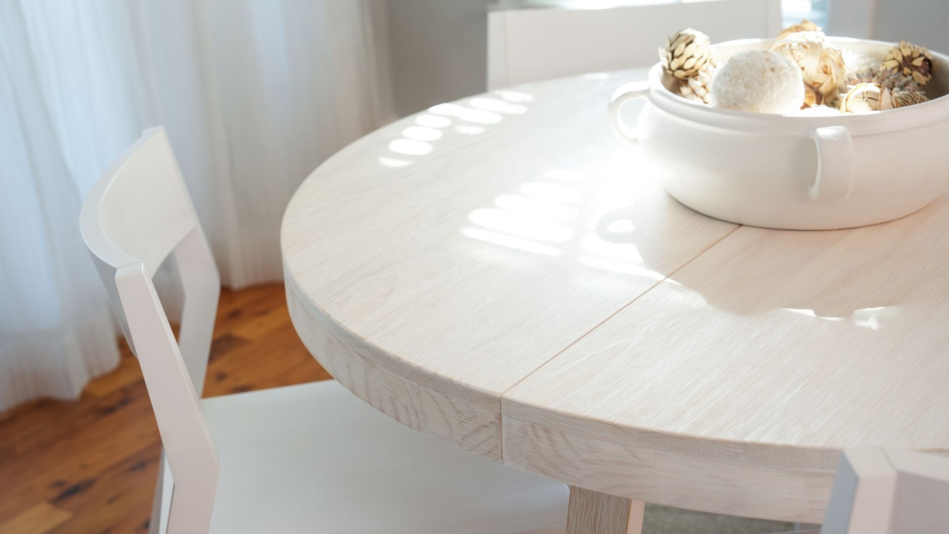 solid wood white dining chair at round kitchen table