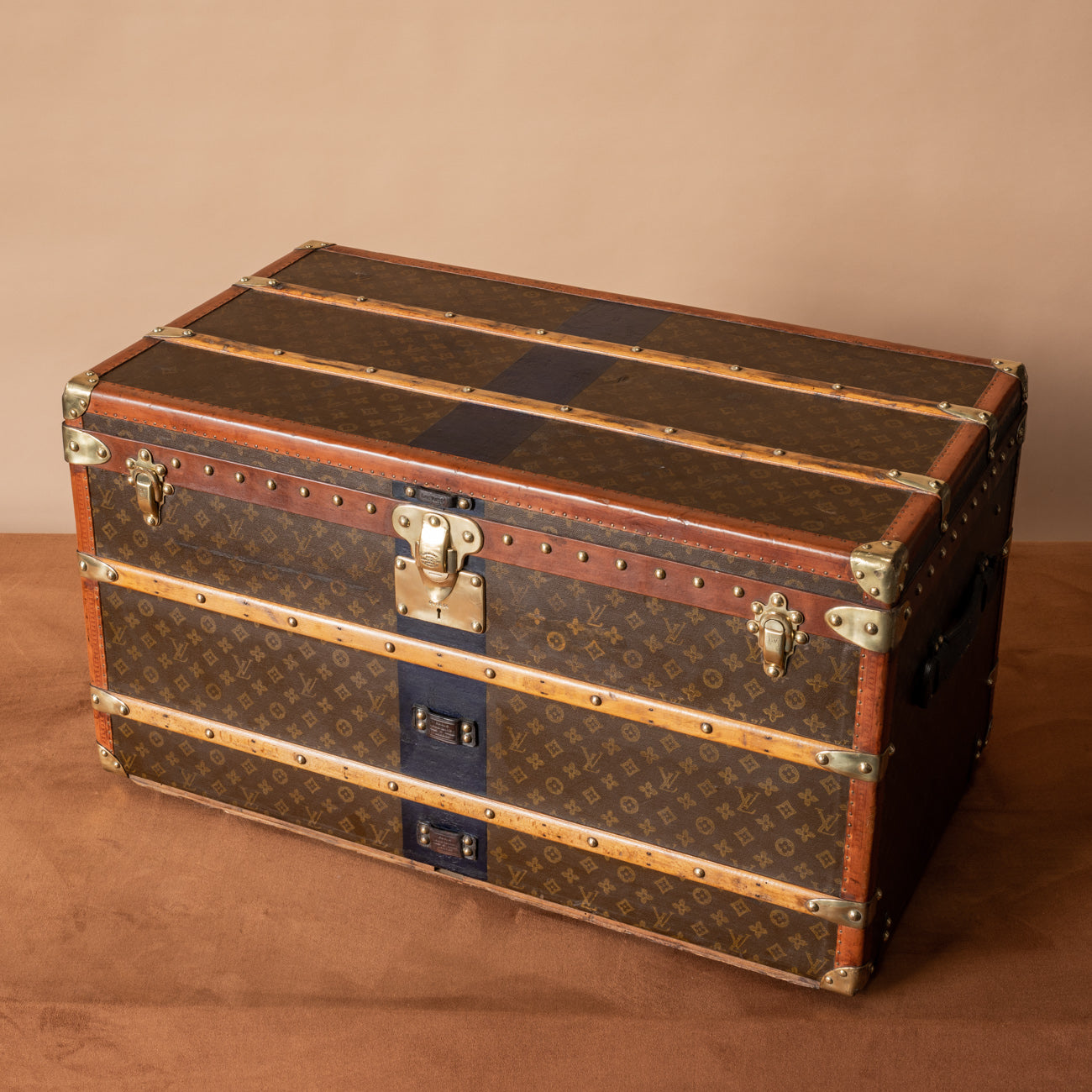 Lot - LOUIS VUITTON STEAMER TRUNK Exterior with allover LV monogram,  beechwood slats, brass locks and hardware, and original casters. One