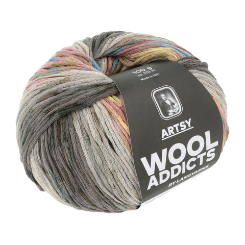 A round ball of Wool Addicts Artsy yarn in earthy tones. Close inspection reveals that the worsted weight yarn has a chainette structure.
