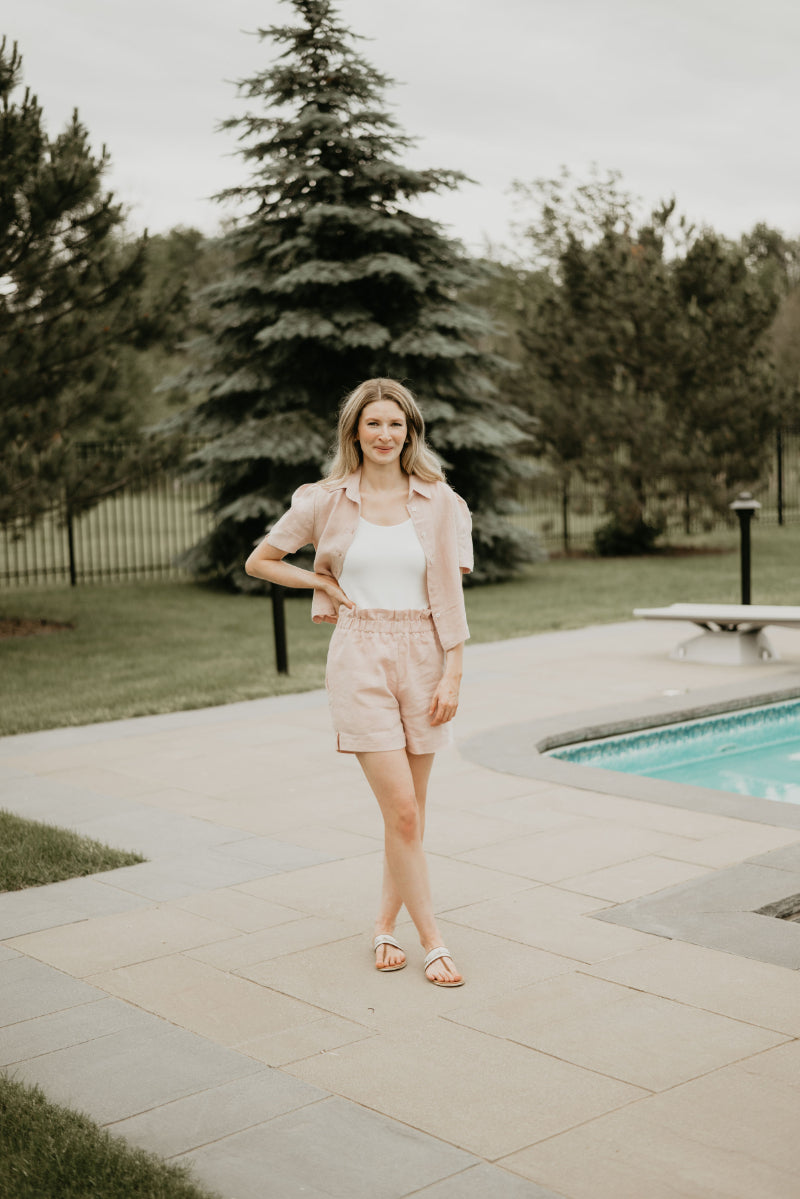 white bodysuit underneath blush shorts and blouse set