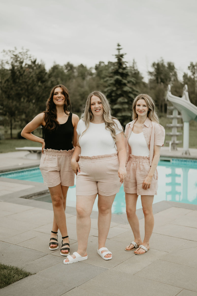 three women wearing bodysuits