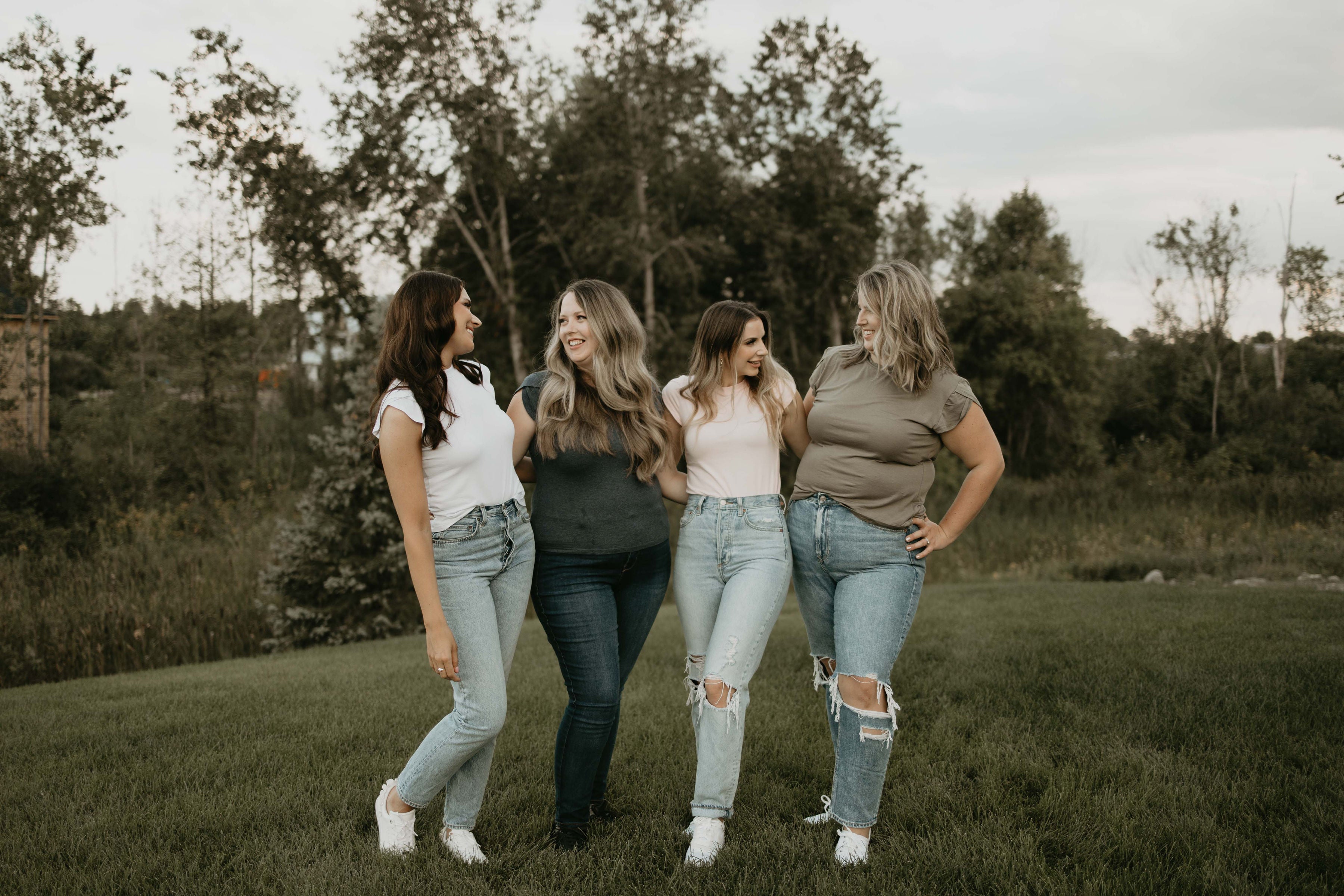 women standing together in jeans and a t-shirt