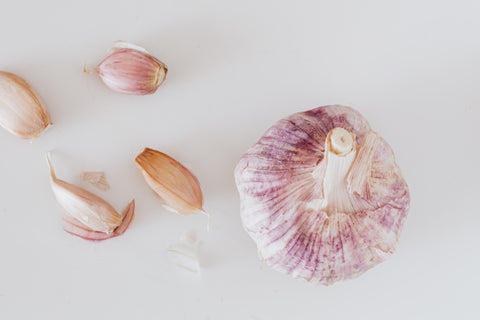 Pieces of garlic on a white background