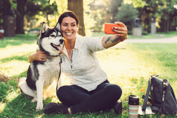 woman taking selfie with dog