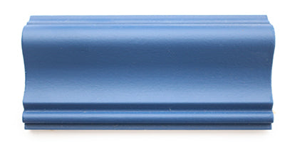 A piece of trim painted blue using a matte paint.